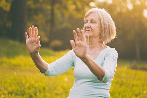 stroke survivor practicing tai chi to promote recovery