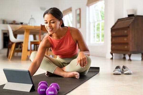 woman setting up her equipment to start her home exercise program for traumatic brain injury