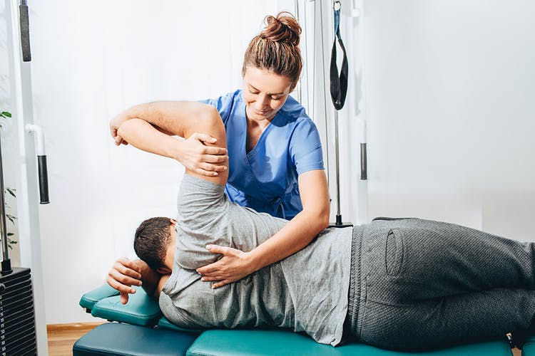 physiotherapist helping tbi patient maximize chances of a full recovery