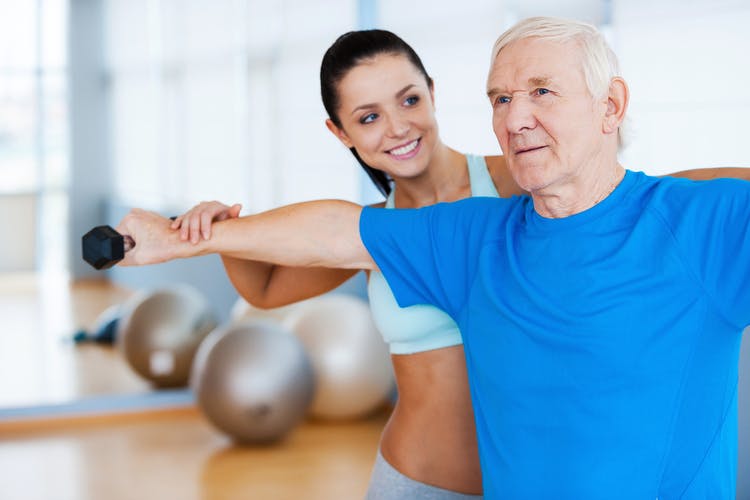 physical therapist helping stroke patient regain muscle function