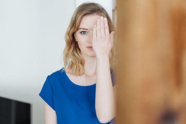woman covering one eye to illustrate the effects of left side neglect after brain injury