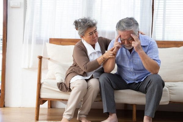 woman consoling husband with headache and worried about what a stroke feels like