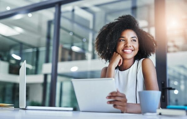 woman sitting down and smiling as she learns how to cope with psychological effects of brain injury