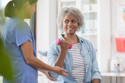 woman with brown sequard syndrome practicing arm exercises with affected side