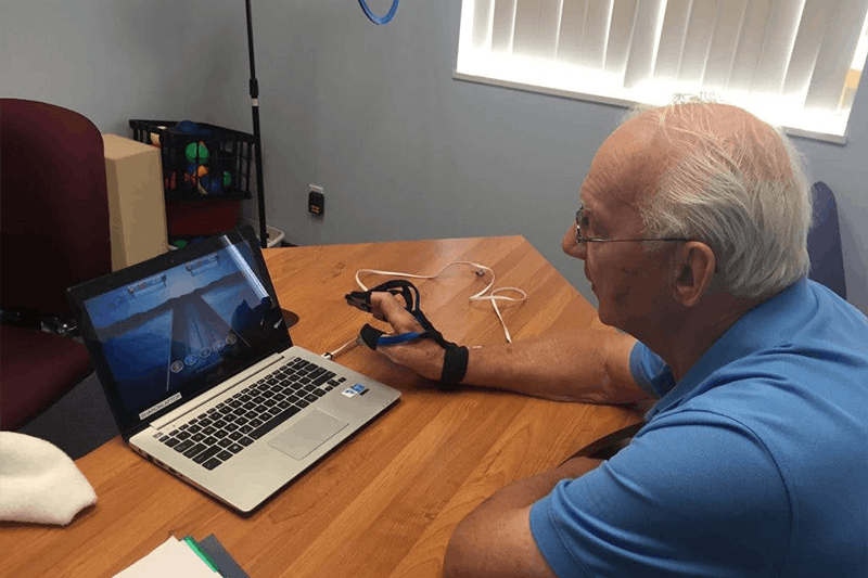 stroke survivor using the musicglove hand therapy device to gain back function in his hand post-stroke